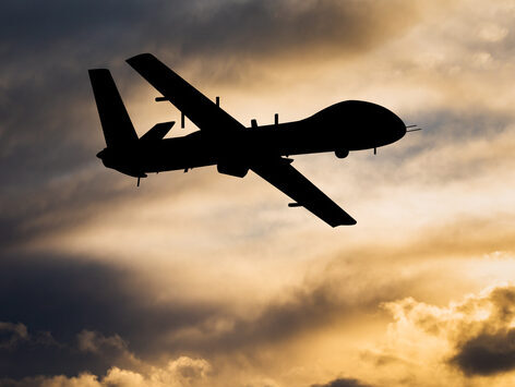 Military unmanned aerial vehicle at sunset. Combat drone in military conflicts