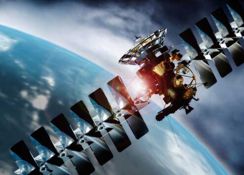 satellite in the Earth's orbit with Earth in the background